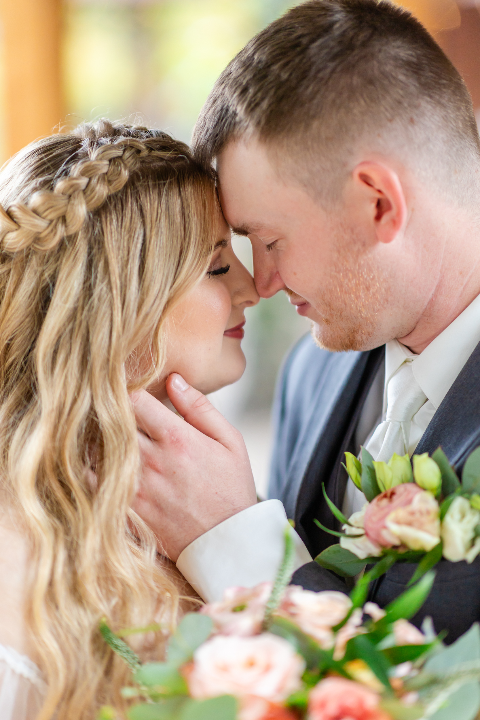 snuggly portrait of the bride and groom with noses and foreheads touching