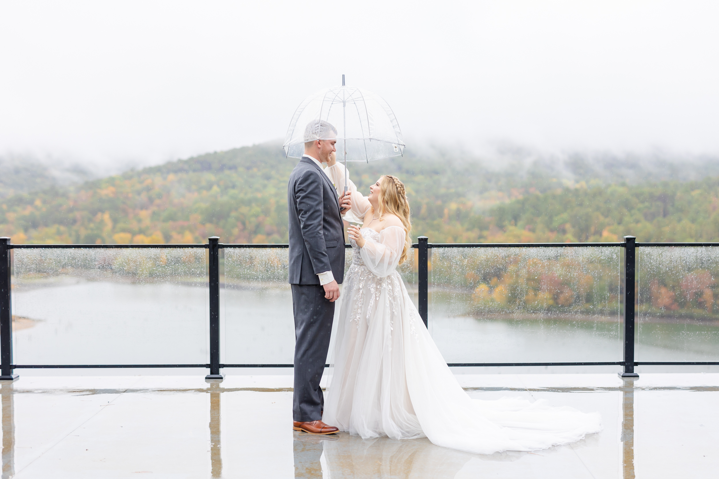 bride wiping tears from her grooms face and fixing his hair